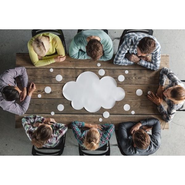 Team Photo of 8 people around a table