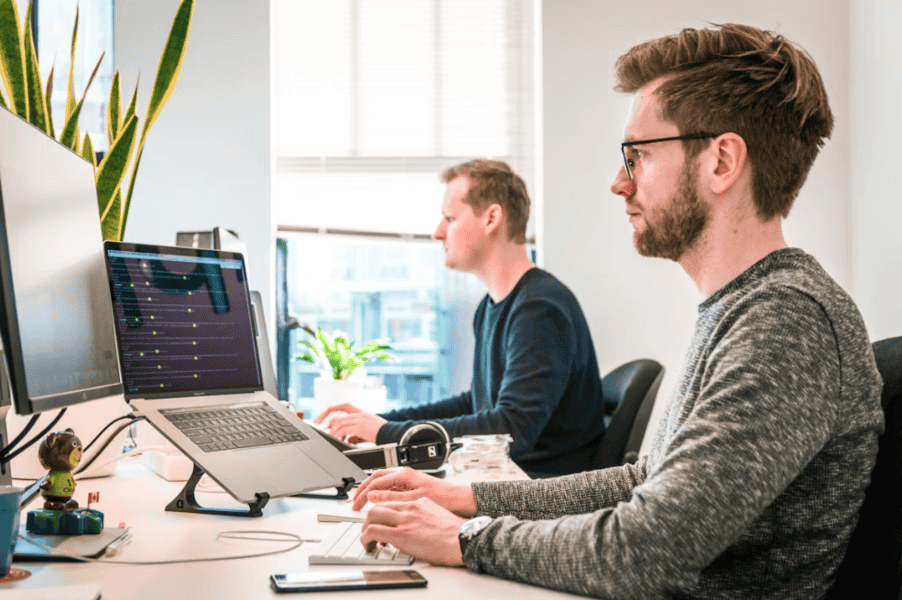 office workers at desks with laptops