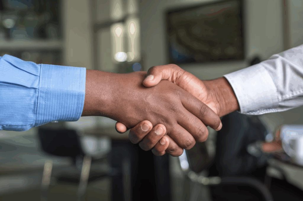 two men handshaking in an office environment