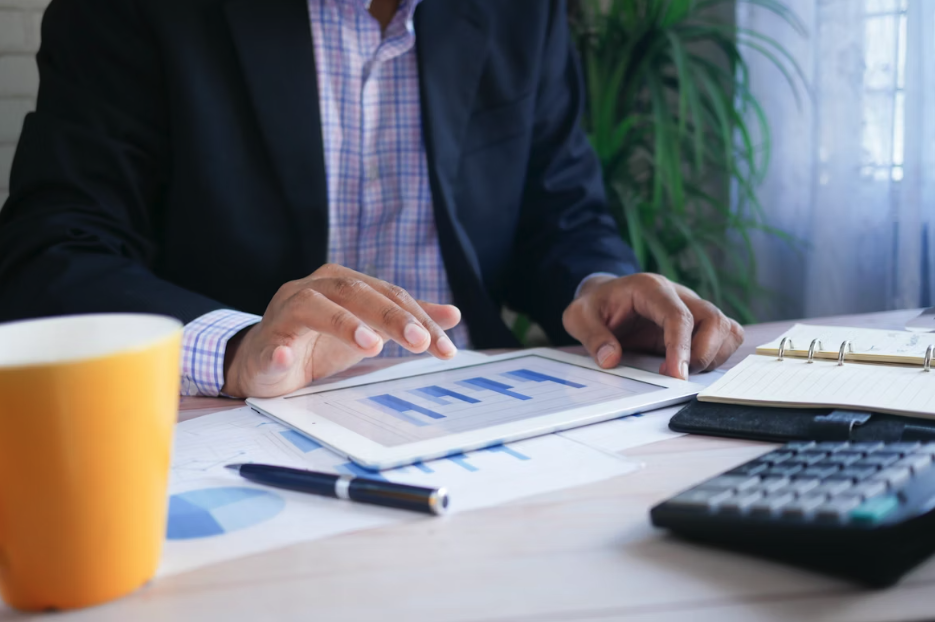 man working out calculations on a laptop