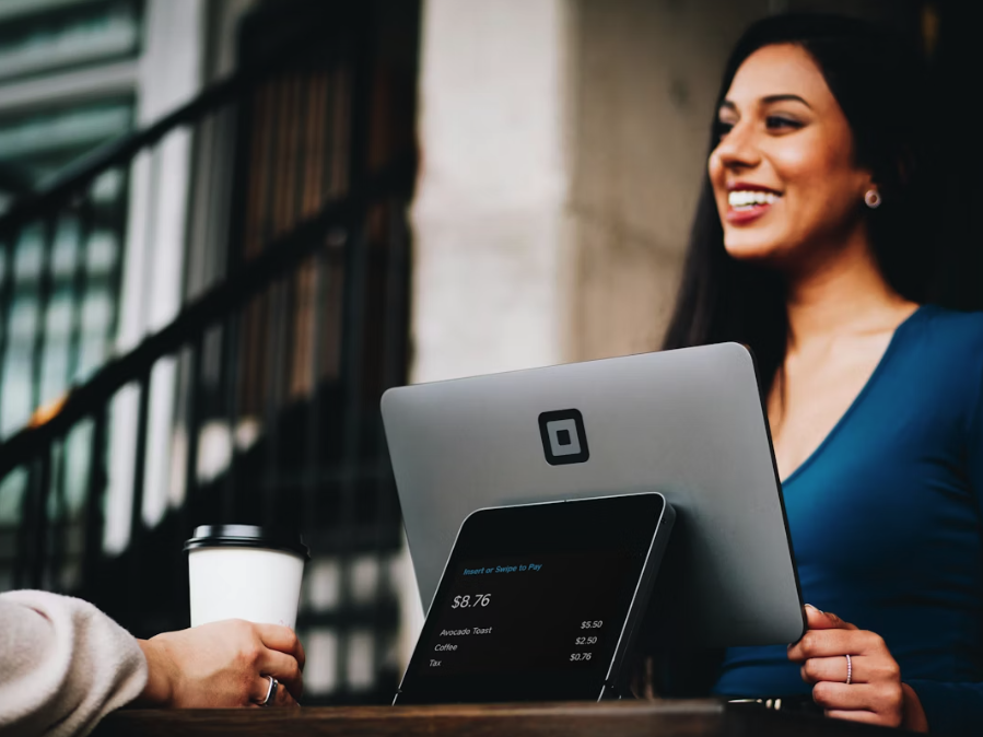 women serving a customer at a till